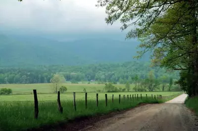 cades cove loop with fog over the mountains