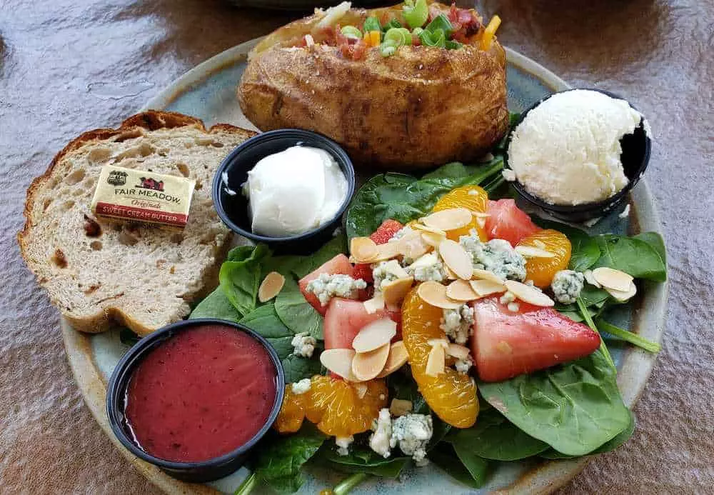 strawberry spinach salad and baked potato with fresh bread