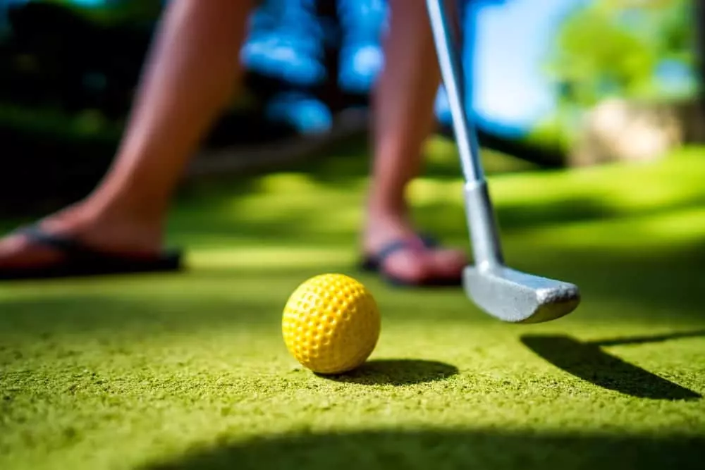 person fixing to hit a golf ball with a club