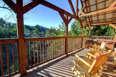 front porch of a cabin on the river in pigeon forge with a hot tub