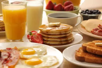 A plate of pancakes and other breakfast items.