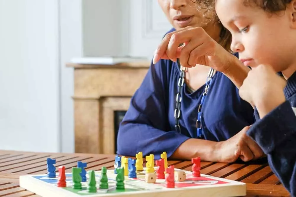 Woman and child playing a board game