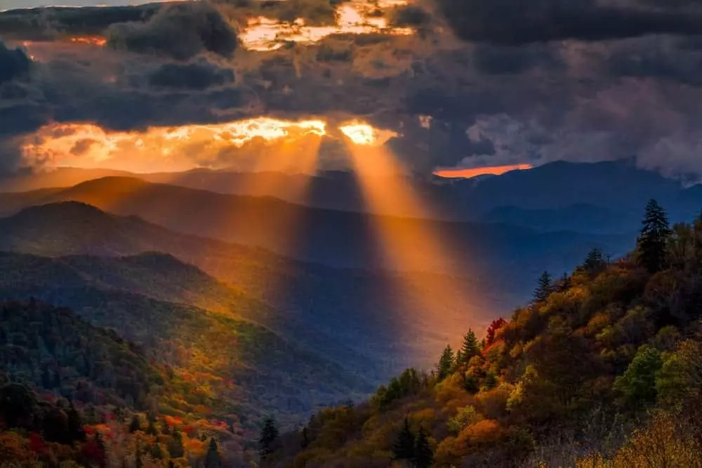Light shines from behind the clouds in the Great Smoky Mountains.