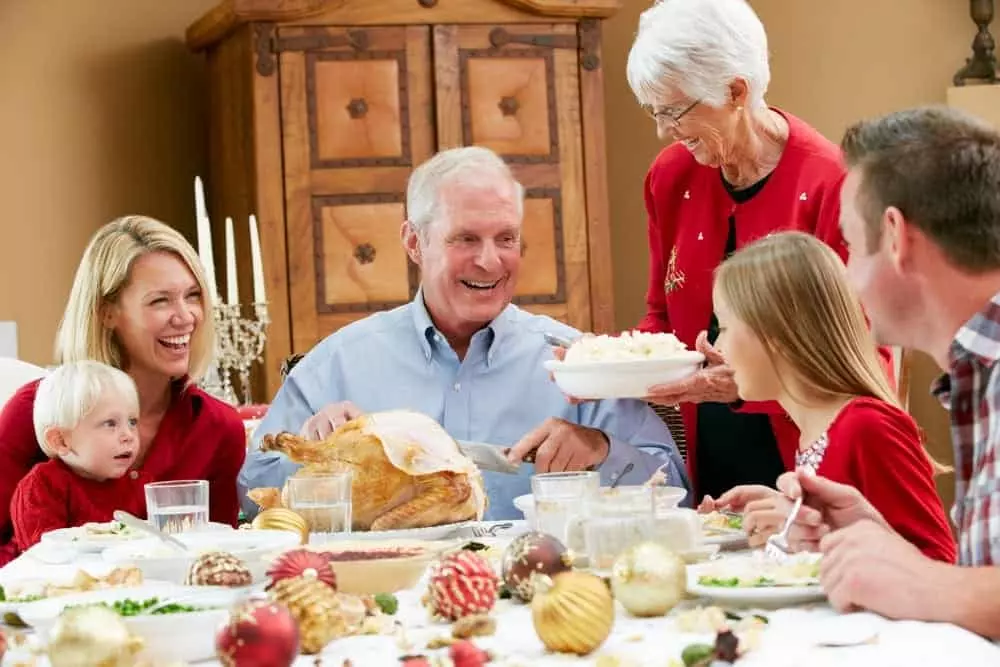 Family eating a big meal together on their Gatlinburg Christmas vacation.