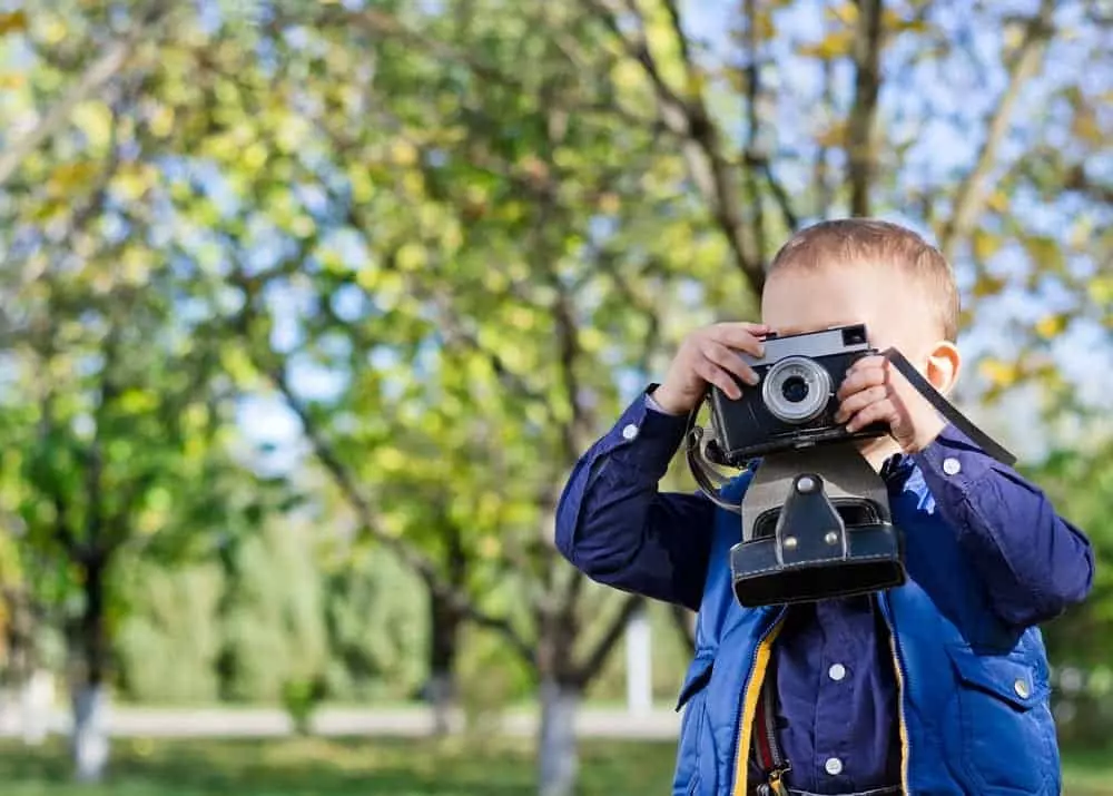 kid taking pictures during a family vacation in Gatlinburg