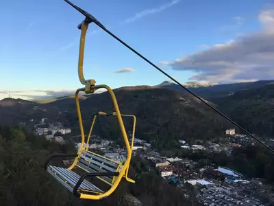 yellow chair going up the mountain at the gatlinburg skylift park
