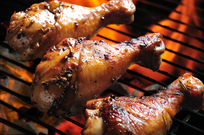 3 grilled chicken legs on grill