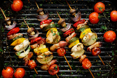 5 vegetable skewers on grill