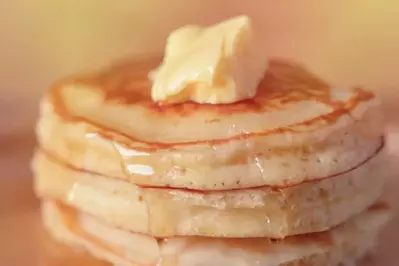 stack of pancakes with butter and syrup