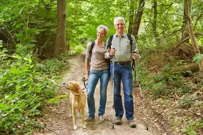 couple hiking in the mountains with dog