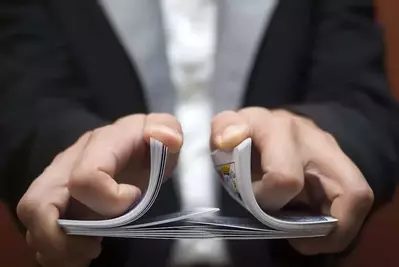 A magician shuffling cards.