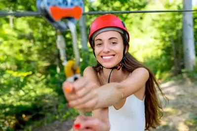 A young woman on a zip line.