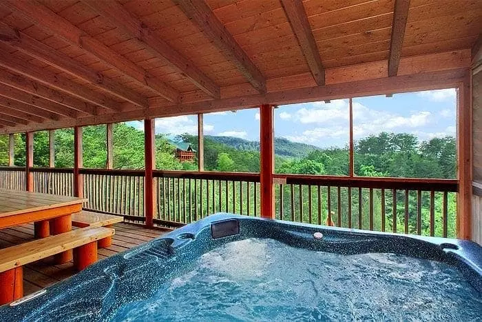 A hot tub on the deck of a large group cabin in Gatlinburg TN.