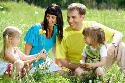 Family in a spring meadow near our vacation rental cabins in Pigeon Forge TN.