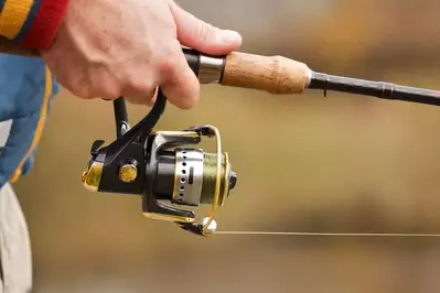 man holding fishing pole at Smoky Mountain fishing cabin