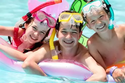 kids swimming in a pool near Pigeon Forge cabins