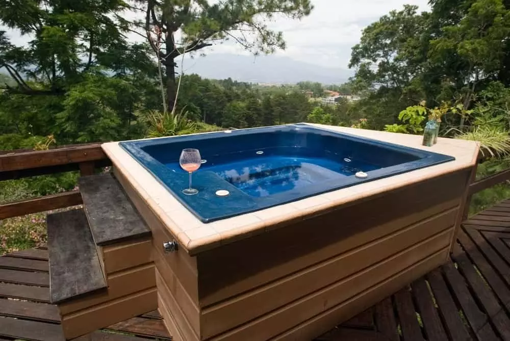 outdoor hot tub on a private deck of a Smoky Mountain luxury cabin rental