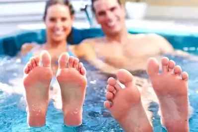 couple in a hot tub in a large group cabin in Pigeon Forge