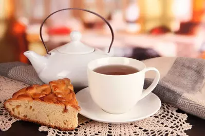 cup of tea with scarf on table in room